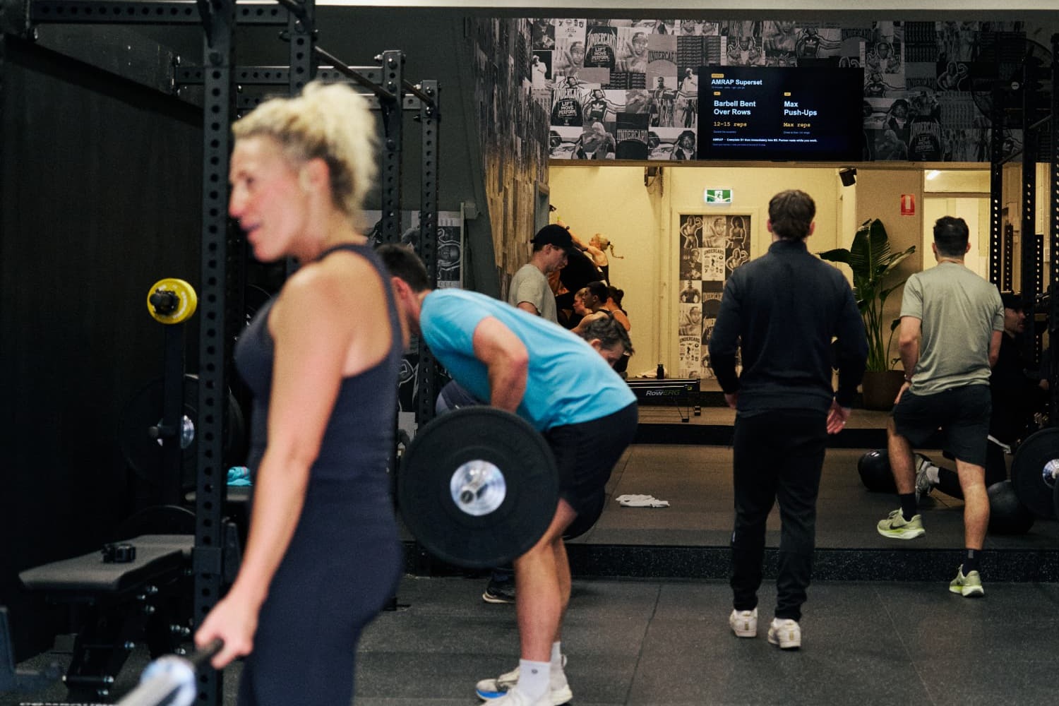 Members lifting barbells on the studio rigs at Undercard Strength Paddington
